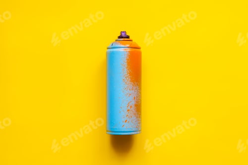 Blue and Orange Spray Paint Can on Yellow