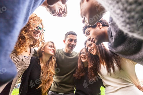 Preview: Multiracial group of friends embraced in a circle