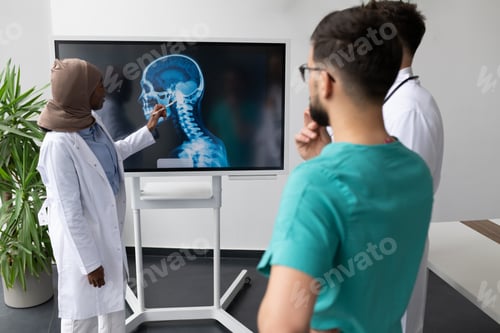 Preview: Medical team examining x ray image on digital screen in hospital