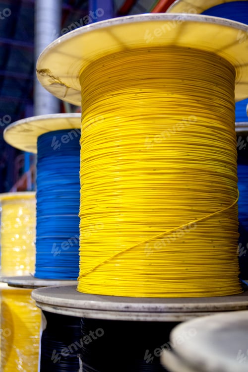 Preview: Group of fiber optic cable reels with intertwined optical fibers