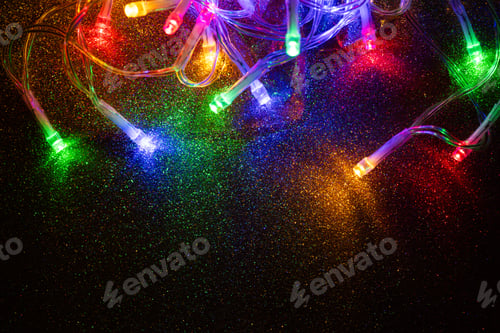 Preview: colorful Christmas lights on dark glitter background