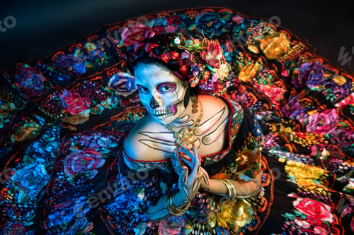 Preview: Latina woman dressed as a Mexican Catrina, with bold skull makeup