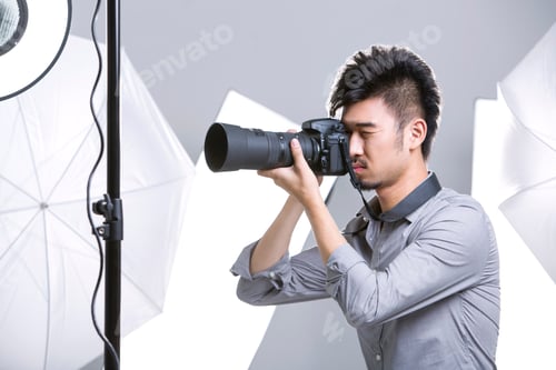 Preview: Photographer taking picture in studio