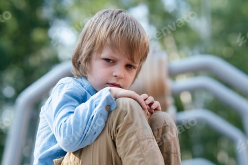 Preview: Sad angry boy on the Playground. Punished, divorce