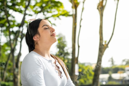 Preview: close-up portrait of a girl meditating in the middle of nature with closed eyes