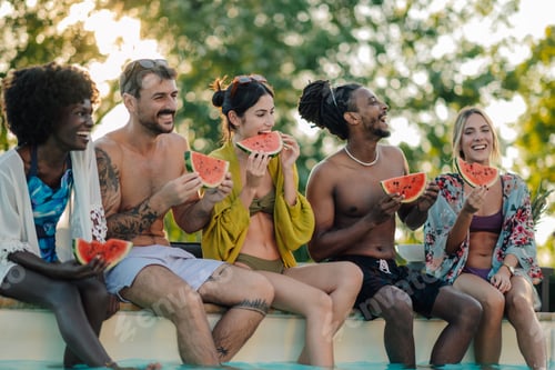 Preview: Happy friends eating watermelon by the pool during summer vacation