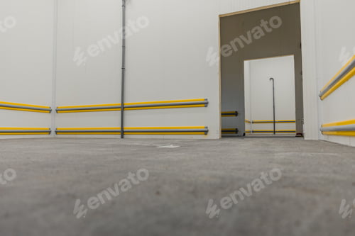Preview: Empty Industrial Room with Protective Bumpers and Doorway
