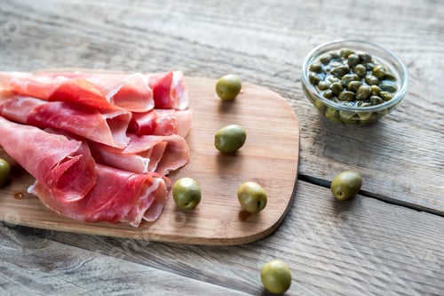 Preview: Jamon with capers and olives on the wooden board