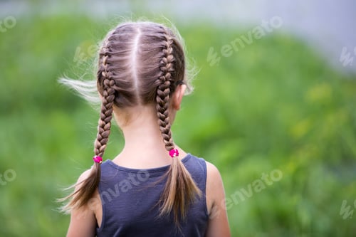 Preview: Child with Braided Hair Outdoors in Green Space