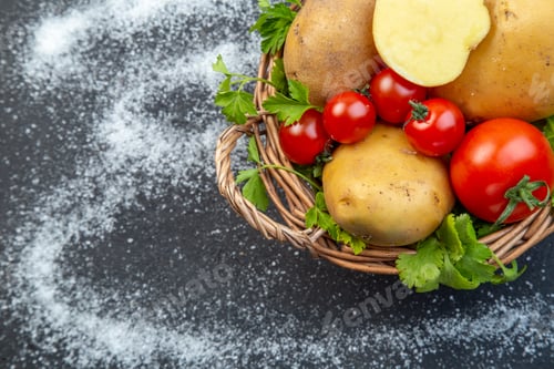 Preview: Half shot of fresh raw vegetables and green in a wooden basket on the left side on a black white