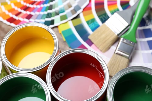 Preview: Paint cans, color palette samples and brushes on table. Closeup view
