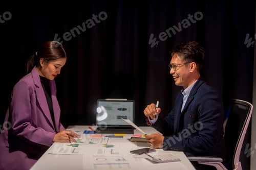 Preview: Two people are sitting at a table, one of them is smiling