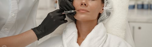 Preview: Cosmetologist makes rejuvenating anti wrinkle injections on face of woman in beauty salon