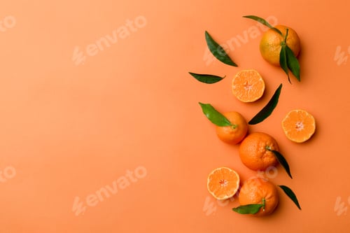 Preview: Many fresh ripe mandarin with green leaves on colored background, top view, space for text