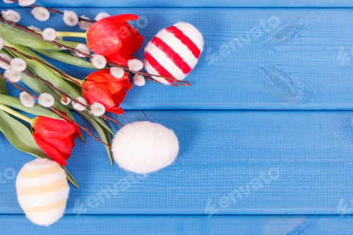 Preview: Red tulips, Easter catkins and eggs wrapped woolen string, festive decoration, copy space for text