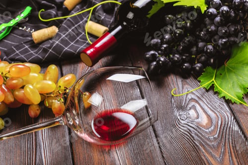 Preview: wine with branches of white grapes. On a wooden table.