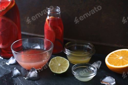 Preview: Citrus cocktail in the different glass dish on the dark stone background