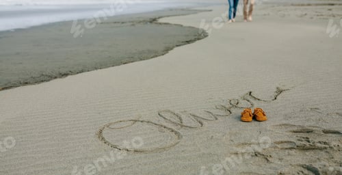 Preview: Baby name written in sand with shoes