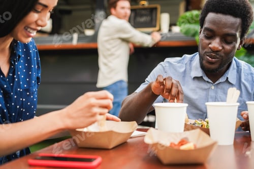 Preview: Multiracial people having fun eating at food truck restaurant outdoor