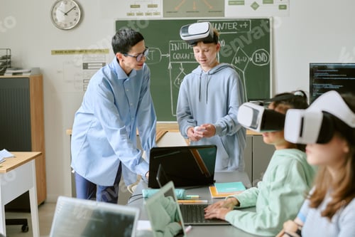 Preview: Middle Aged Caucasian Woman Teaching Teenagers Using Virtual Reality Headsets