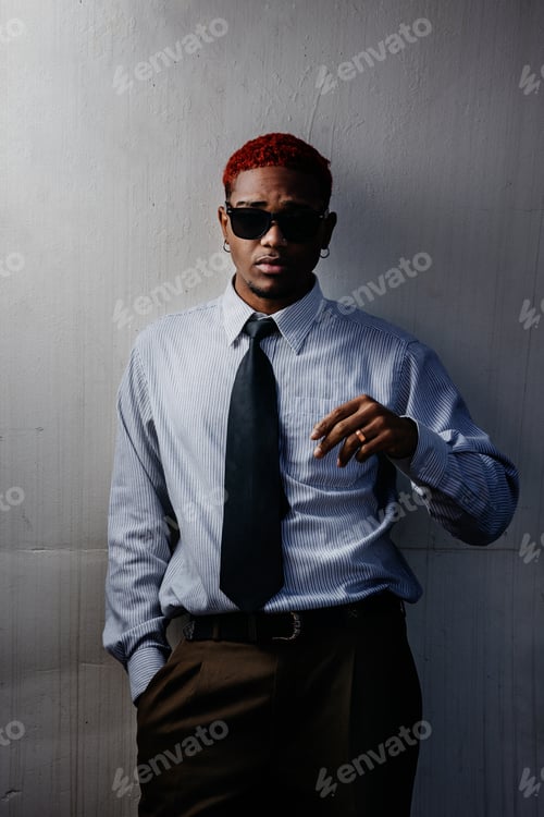 Preview: Portrait of an executive leaning on a wall looking at the camera