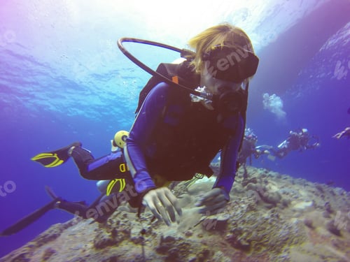 Preview: Underwater scuba diving selfie shot with selfie stick. Deep blue sea. Wide angle shot.