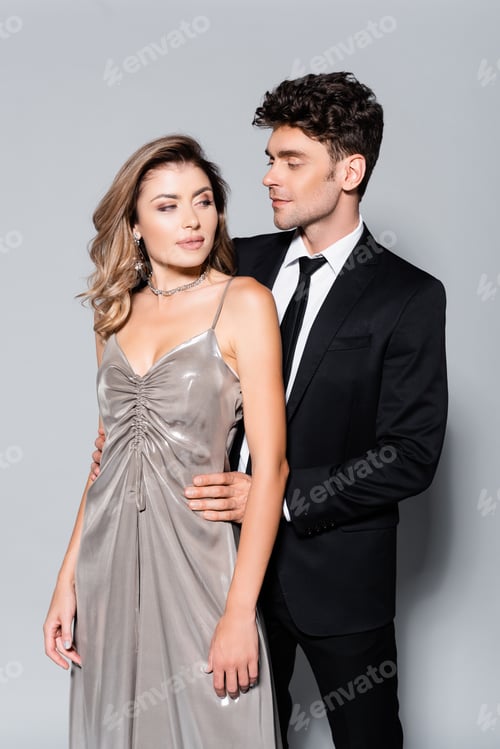 Preview: elegant young couple posing isolated on grey