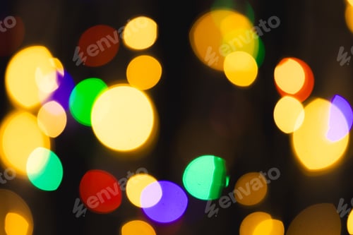 Preview: Multi coloured bokeh lights with copy space on dark background