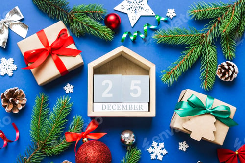 Preview: Christmas calendar 25 december. Christmas gift, fir branches, pine cones. Flat lay