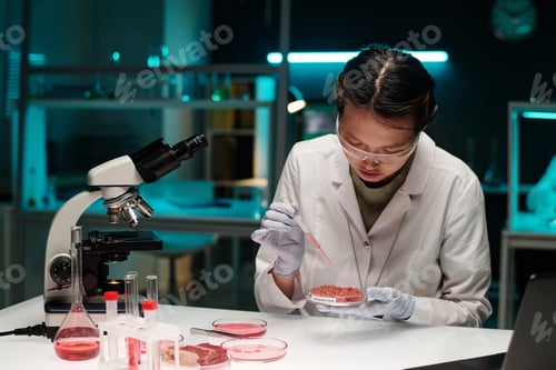 Preview: Female Researcher Dispensing Liquid on Meat Sample