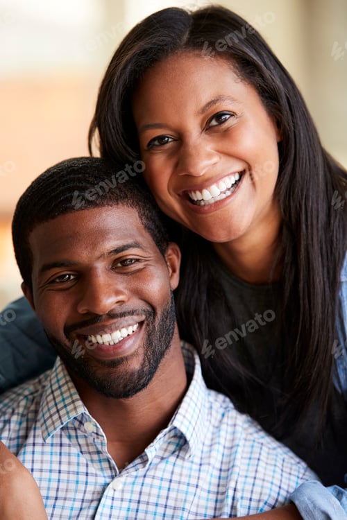 Vista previa: Portrait Of Smiling Loving Couple Hugging At Home