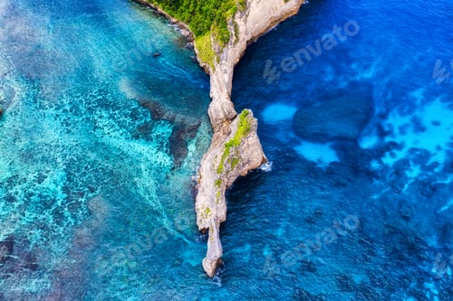 Preview: Aerial view on the sea and rocks. Blue water background from top view.