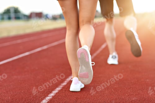 Preview: Man and woman racing on outdoor track