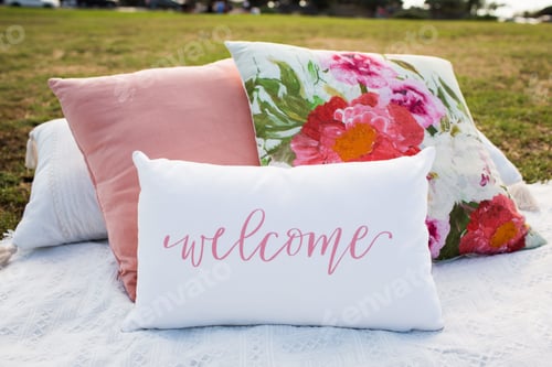 Preview: Pillows in the garden with floral print and with a writing "welcome"
