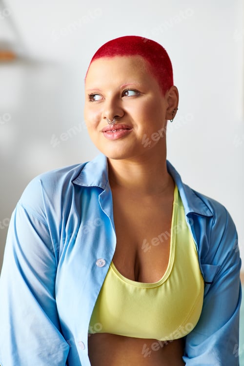 Preview: Young woman with red hair enjoys a moment of relaxation at home in cozy attire