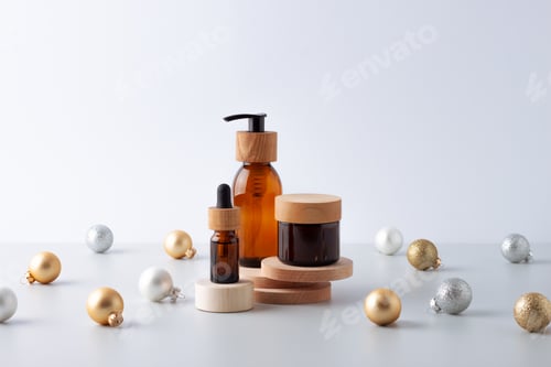 Preview: Christmas cosmetic product display. Natural skin care products on podium with Christmas balls