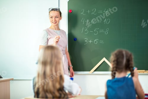 Preview: teacher with marker standing at white board at lecture