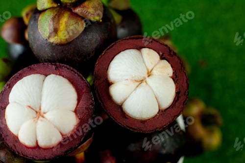 Preview: Fresh mangosteen fruits and cross section showing the thick purple skin and white flesh.
