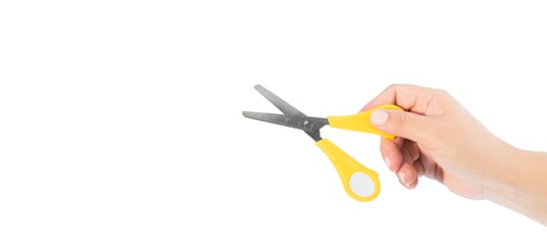 Preview: woman's hand holding yellow scissors on white background