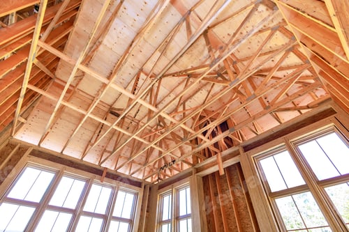 Preview: Unfinished framing beams on wooden house in construction site of a new home