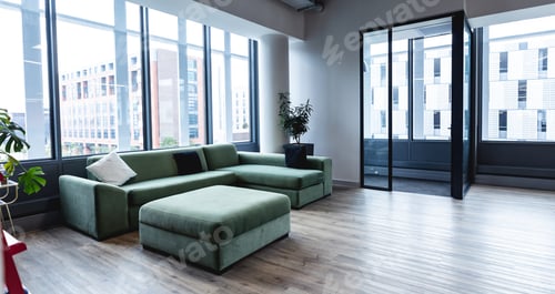 Preview: Interior of empty modern office with sofa and windows