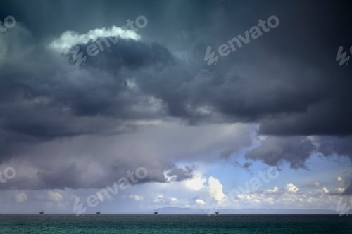 Preview: Stormy sky over oil drilling platforms in ocean