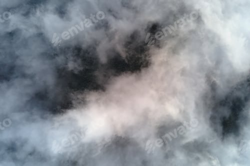 Preview: Aerial view from high altitude of earth covered with puffy rainy clouds forming before rainstorm