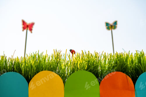 Preview: Close up of small green grass with special cute toys small butterflies. Concept of beautiful plants