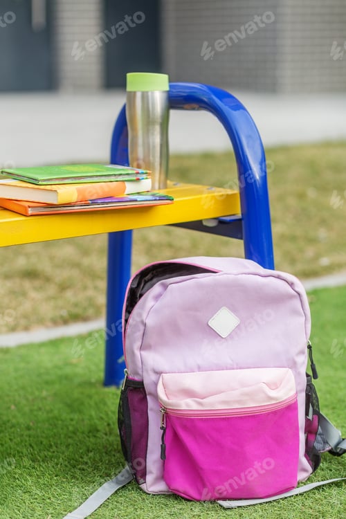 Preview: Backpack and Books on School Playground Desk