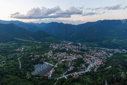 Preview: Mountain valley sheltered by vegetation and spruce forests with village of Smolyan