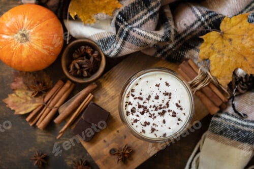 Preview: Pumpkin latte spice coffee, warm scarf and maple leaves on rustic background.