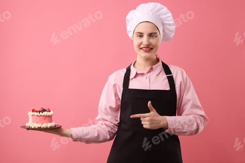 Preview: Confectioner holding delicious cake on pink background