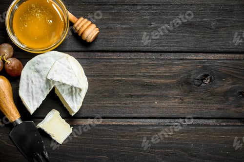 Preview: Brie cheese with honey and grapes.