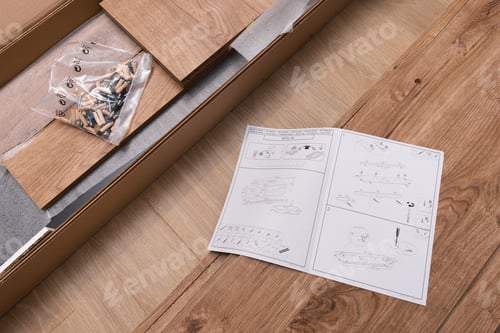 Preview: Furniture assembling plan, dowels, nails and door latch on wooden background